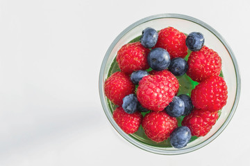 raspberry on top of a jelly with rapsberries and blueberries