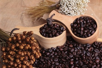 Roasted coffee beans on sack brown background.