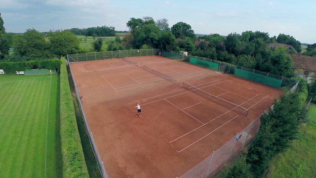 Flying around tennis court person playing alone