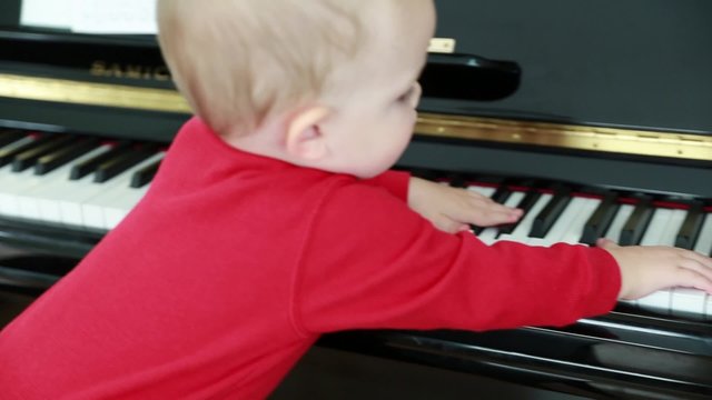 cute little toddler playing on the piano