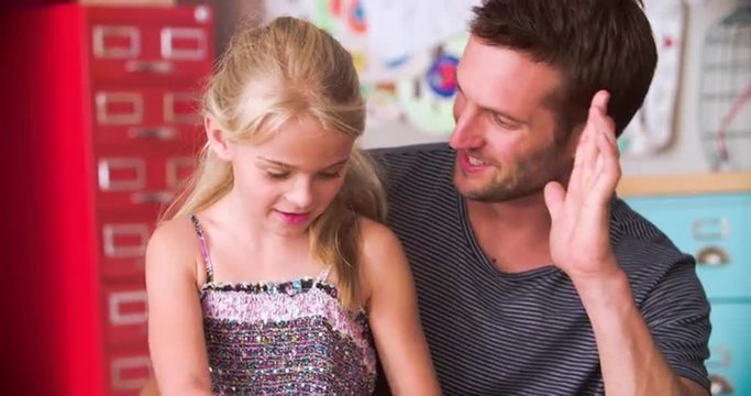 Father And Daughter Coloring Picture In Child's Bedroom