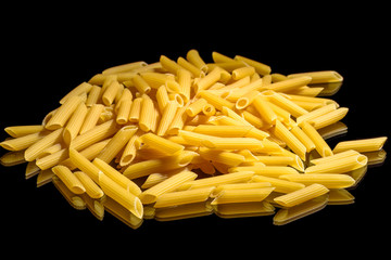 Heap of macaroni noodles reflecting on black background