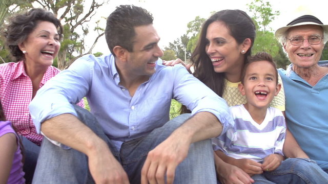 Slow Motion Shot Of Multi Generation Family Sitting In Park