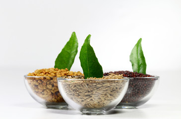 Cumin,fenugreek seeds and mustard seeds with curry leaves, shallow depth of field