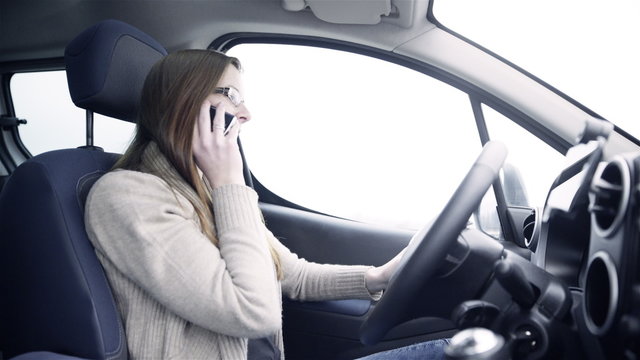 Woman in car on cell phone