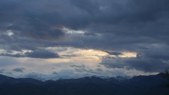 Timelapse storm clouds above mountain range