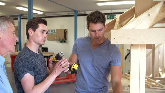 Teacher Helping College Student Studying Carpentry