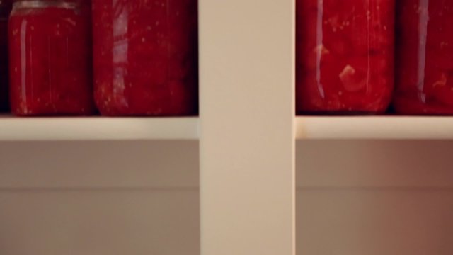 preserved food in jars on a storage shelf