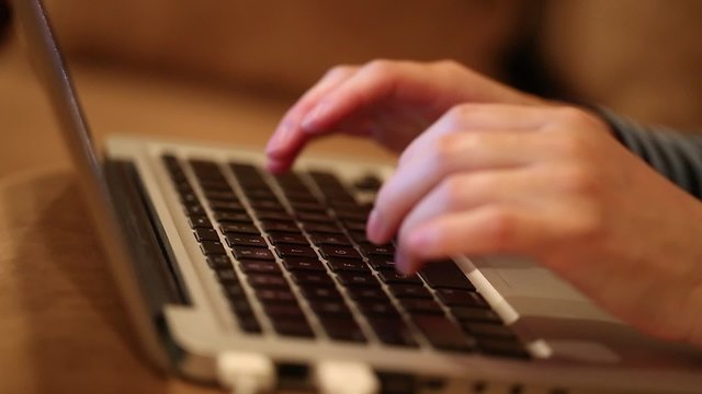 Closeup hand of woman using laptop computer