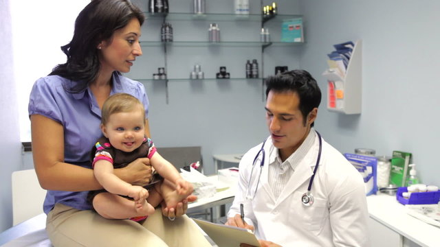Mother And Baby Visiting Doctor's Office