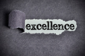 excellence word under torn black sugar paper