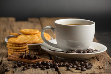 Cup of coffee on a wooden board and biscuits