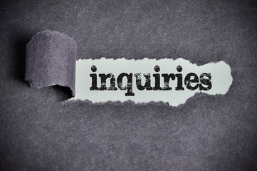 inquiries word under torn black sugar paper