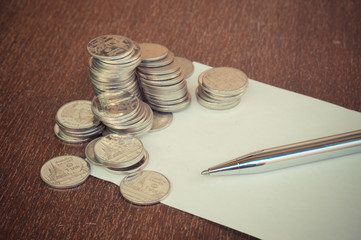 Pen and coins with filter effect retro vintage style