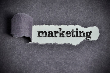 marketing word under torn black sugar paper