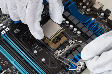Person Installing Central Processor In Motherboard