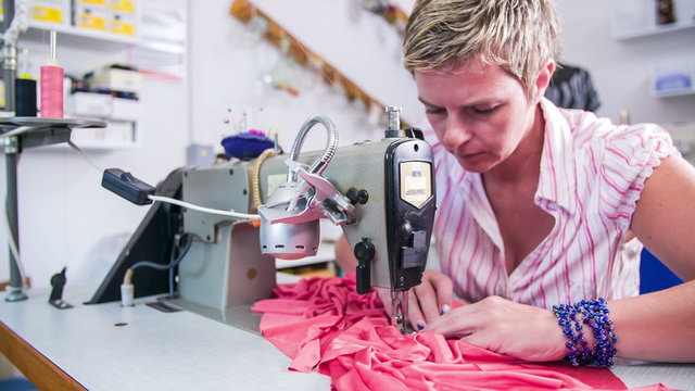 Sewing together textile making a dress on sewing machine