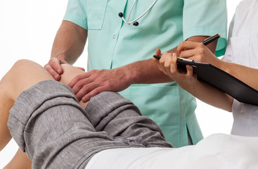 Orthopedist diagnosing patient's knee