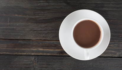 a cup of chocolate on wood table