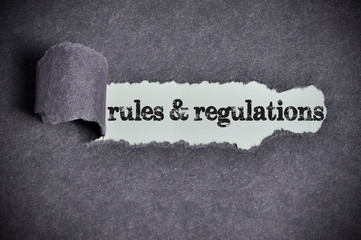 regulations word under torn black sugar paper