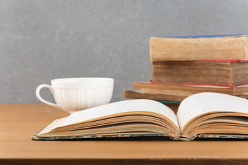 old book with books stack and coffee