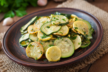Warm salad with young zucchini with garlic and herbs
