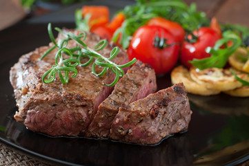 Closeup of grilled beef steak with vegetables