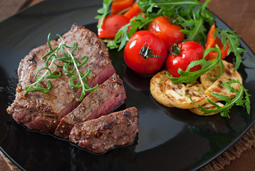 Closeup of grilled beef steak with vegetables