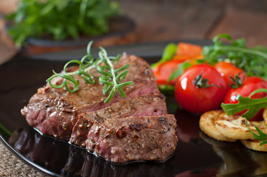 Closeup of grilled beef steak with vegetables