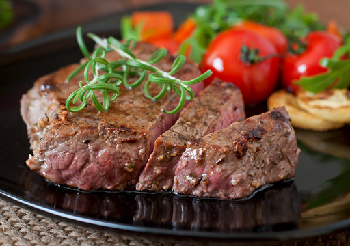 Closeup of grilled beef steak with vegetables