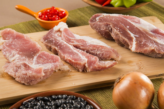 Pig loin raw in wooden background