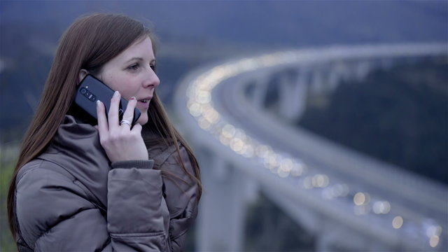Woman in traffic jam taking a mobile call