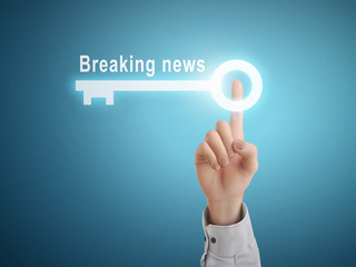 male hand pressing breaking news key button