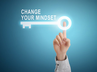 male hand pressing change your mindset key button