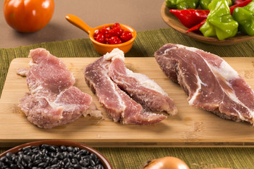 Pig loin raw in wooden background