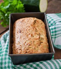 Zucchini bread with cheese on a wooden background