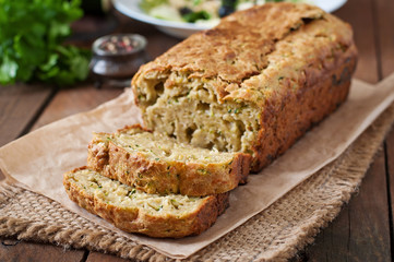 Zucchini bread with cheese on a wooden background