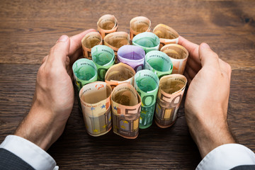 Businessman Protecting Banknotes
