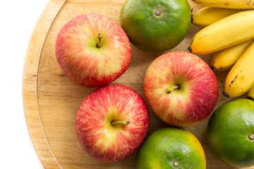 Apple, Orange and banana on wood tray, white background