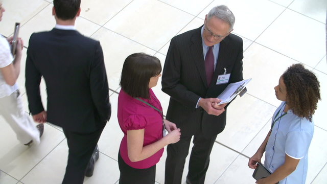 Overhead View Of Hospital Staff Meeting In Busy Reception