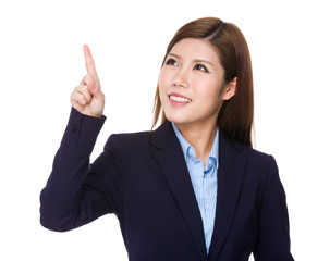 Young businesswoman look at the finger touch on the imaginary pa