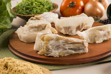 Raw pig tails on wooden background