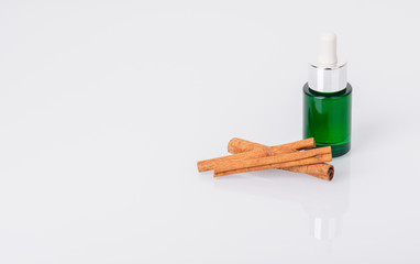 Bottle of aromatic oil and cinnamon sticks