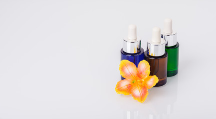 Bottles of aromatic essential oils and a flower candle