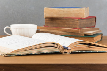 old book with pencil and coffee