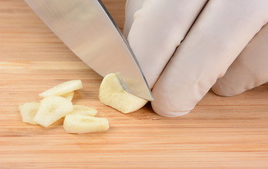 Fototapeta na wymiar Chef Slicing Garlic
