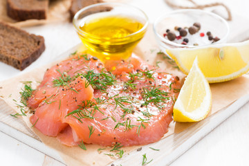 appetizer - salted salmon and bread on a wooden board