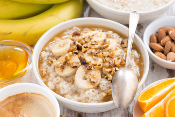 healthy breakfast - oatmeal with banana, honey and walnuts 