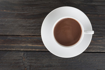 a cup of chocolate on wood table