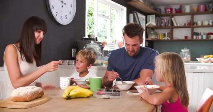 Family Eating Breakfast In Kitchen Together